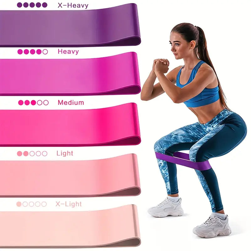 Woman exercising with resistance bands of different colors and strengths on a white background