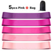 Set of pink resistance bands with a black bag on a white background