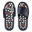 Pair of black acupressure sandals with white and red nodes on a white background