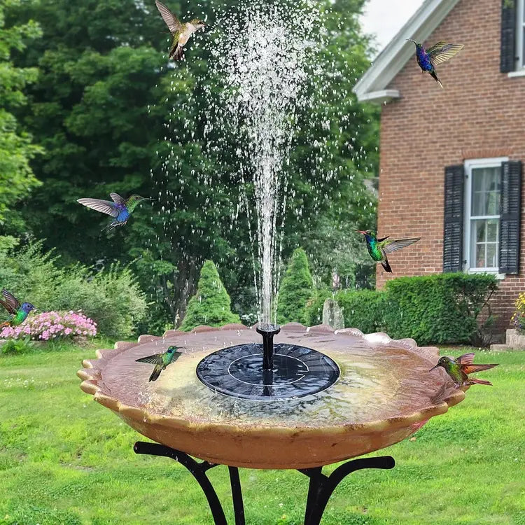 Solar-powered bird bath with water fountain in a garden setting