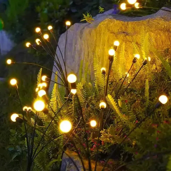 Decorative string lights on plants with a natural background